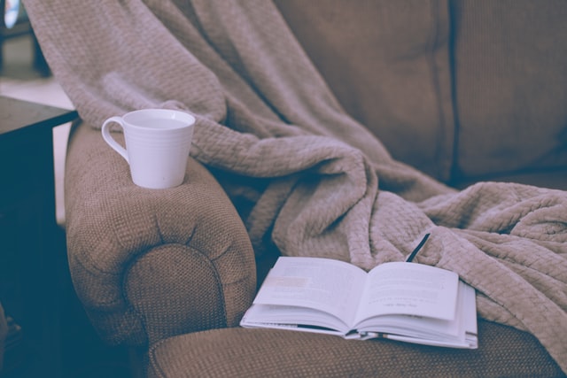 cozy couch with teacup and open book