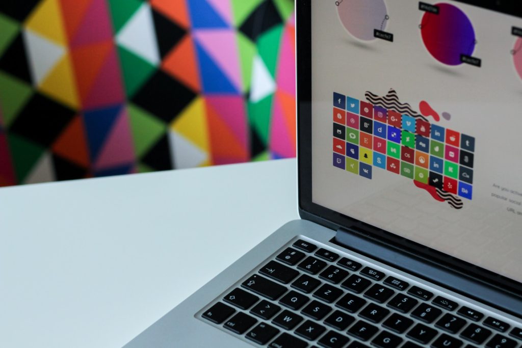 computer screen with colorful icons with a colorful wall background