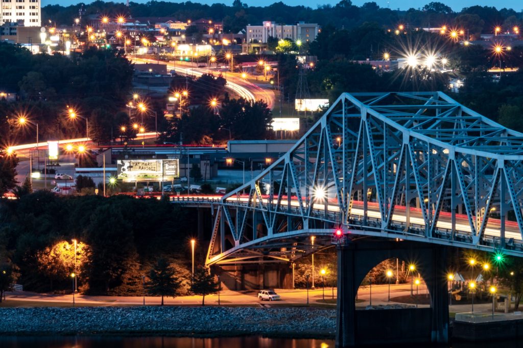 night time shot of a bridge and the city of Florence in The Shoals region of Alabama