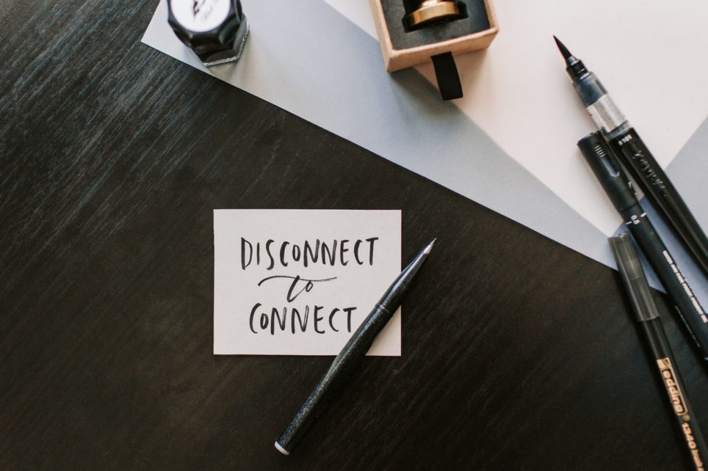 disconnect to connect calligraphy on a piece of paper with pens and ink on table