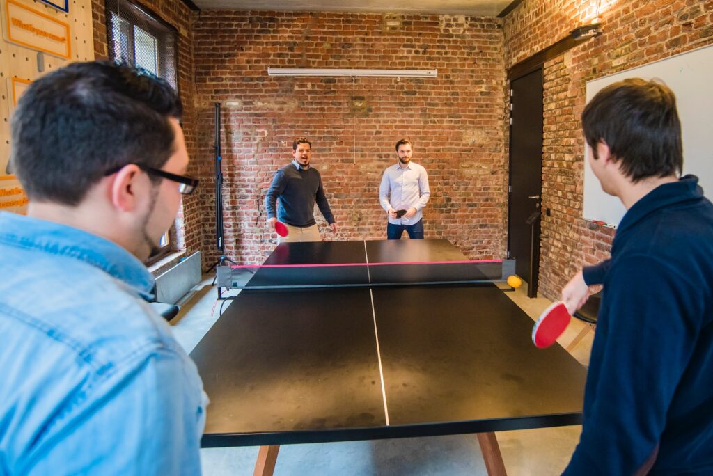 Four men playing ping pong 