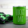Green mug that says "Lucky Day"