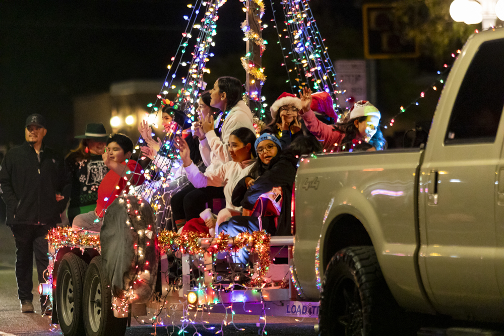 People on a holiday float for the Tucson Downtown parade of lights