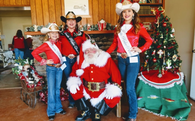 Three people posing with Santa at Empire Ranch in Tucson