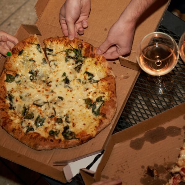 People eating pizza with wine