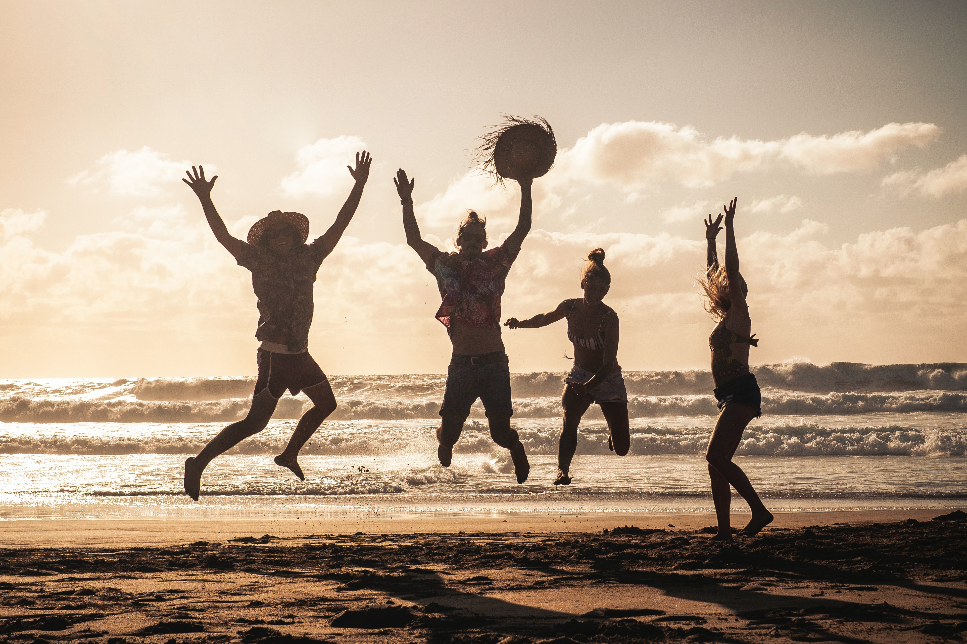 People jumping together on a beach