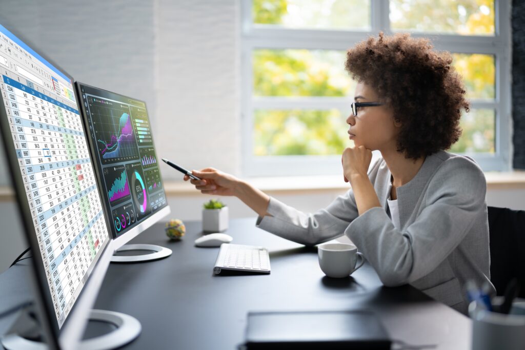Woman looking at graphs on a computer