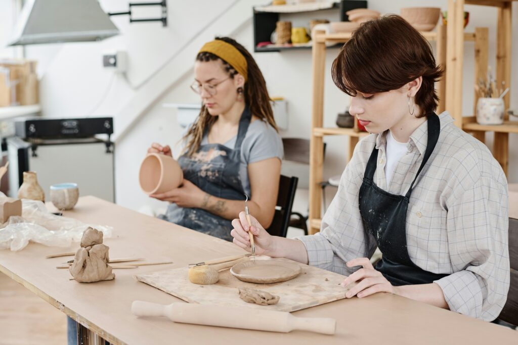 Two friends making pottery together