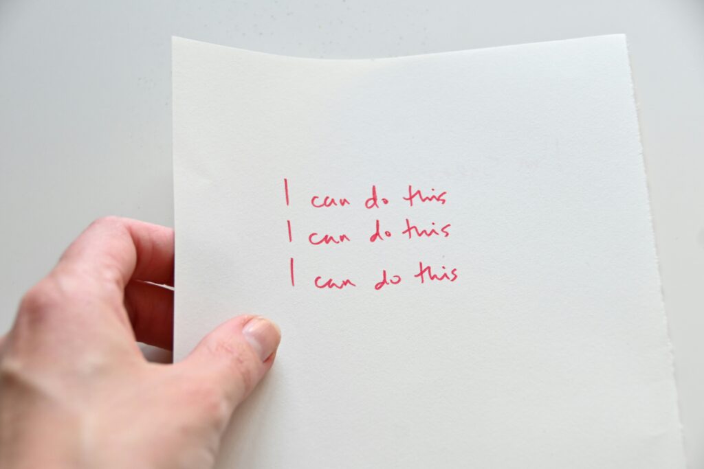 Paper with the text "I can do this" written three times.