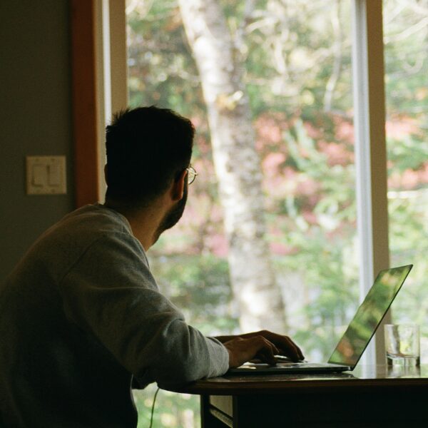 Man working at his home office, looking out the window